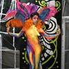 Beautiful entertainer in colorful body suit and feathers boosts entertainment value of New York City event