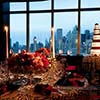 Floral center pieces featured with Wedding Cake with NYC skyline in background from NYC Wedding 